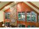 High-ceilinged living room with stone fireplace and large windows at 4390 Saxon Dr, New Smyrna Beach, FL 32169
