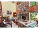 Bright living room with a stone fireplace and large windows at 4390 Saxon Dr, New Smyrna Beach, FL 32169
