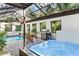 Inviting pool and hot tub area with covered patio at 4390 Saxon Dr, New Smyrna Beach, FL 32169