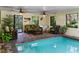 Cozy pool area with seating and tropical plants at 4390 Saxon Dr, New Smyrna Beach, FL 32169