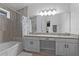 Double vanity bathroom with granite countertop and tile shower at 440 Macgregor Rd, Winter Springs, FL 32708