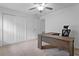 Bright bedroom with L-shaped desk and double door closet at 440 Macgregor Rd, Winter Springs, FL 32708