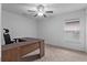 Bedroom with L-shaped desk and window with blinds at 440 Macgregor Rd, Winter Springs, FL 32708
