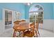 Bright dining room with wooden table, chairs, and large window at 440 Macgregor Rd, Winter Springs, FL 32708