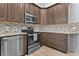 Modern kitchen with stainless steel appliances and granite countertops at 440 Macgregor Rd, Winter Springs, FL 32708