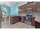 Modern kitchen with dark brown cabinets and granite countertops at 440 Macgregor Rd, Winter Springs, FL 32708