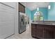 Bright kitchen, stainless steel refrigerator, granite countertop, and teal accent wall at 440 Macgregor Rd, Winter Springs, FL 32708