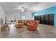 Open living area with hardwood floors, brown leather furniture, and a blue accent wall at 440 Macgregor Rd, Winter Springs, FL 32708