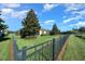 Backyard view showing a fenced area, lawn, and trees at 5106 Nw 35Th Lane Rd, Ocala, FL 34482