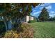 Landscaped backyard with a screened patio and lush greenery at 5106 Nw 35Th Lane Rd, Ocala, FL 34482