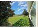 Backyard with lush grass, shrubs, and a view of the golf course at 5106 Nw 35Th Lane Rd, Ocala, FL 34482