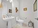 Small bathroom with toilet and pedestal sink at 5106 Nw 35Th Lane Rd, Ocala, FL 34482