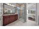 Spa-like bathroom featuring a walk-in shower and a vanity with granite countertop at 5106 Nw 35Th Lane Rd, Ocala, FL 34482