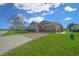 Tan two-car garage home with a nicely landscaped lawn at 5106 Nw 35Th Lane Rd, Ocala, FL 34482