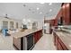 Open kitchen with island, wine cooler, and stainless steel appliances at 5106 Nw 35Th Lane Rd, Ocala, FL 34482