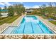 Community lap pool with spacious deck and lounge chairs at 5106 Nw 35Th Lane Rd, Ocala, FL 34482