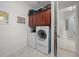 Laundry room with washer, dryer, and upper cabinets at 5106 Nw 35Th Lane Rd, Ocala, FL 34482
