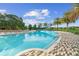 Community pool with shade umbrellas and lounge chairs at 5106 Nw 35Th Lane Rd, Ocala, FL 34482