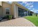 Outdoor screened patio with paver stones and lush green landscaping at 5106 Nw 35Th Lane Rd, Ocala, FL 34482