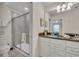 Bathroom with double vanity, granite countertop, and shower at 5437 Misty Oak Cir, Davenport, FL 33837