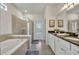 Spa-like bathroom with soaking tub, walk-in shower, and dual vanity at 5437 Misty Oak Cir, Davenport, FL 33837