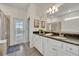 Main bathroom with double vanity, granite countertop, and shower at 5437 Misty Oak Cir, Davenport, FL 33837