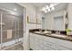 Bathroom with double vanity, granite countertop, and walk-in shower at 5437 Misty Oak Cir, Davenport, FL 33837