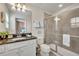 Bathroom with double vanity, granite countertop, and shower at 5437 Misty Oak Cir, Davenport, FL 33837