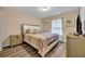 Bedroom with queen bed, light wood floors, and gold accents at 5437 Misty Oak Cir, Davenport, FL 33837