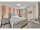 Bedroom with gray upholstered bed and orange striped wall at 5437 Misty Oak Cir, Davenport, FL 33837