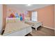 Bedroom with two twin beds featuring a Disney Princess mural at 5437 Misty Oak Cir, Davenport, FL 33837