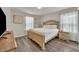Bedroom with a queen bed, light wood frame, and neutral decor at 5437 Misty Oak Cir, Davenport, FL 33837
