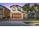 Two-story house with brown brick garage and driveway at 5437 Misty Oak Cir, Davenport, FL 33837