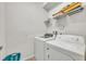 Laundry room with Whirlpool washer and dryer, and shelving at 5437 Misty Oak Cir, Davenport, FL 33837