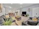 Open living room featuring a comfortable seating area and flat-screen TV at 5437 Misty Oak Cir, Davenport, FL 33837