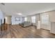 Living area with gray sofa and wood-look floors at 5437 Misty Oak Cir, Davenport, FL 33837