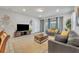 Bright living room with access to a patio and neutral decor at 5437 Misty Oak Cir, Davenport, FL 33837
