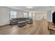 Spacious living room featuring gray sectional sofa and wood-look floors at 5437 Misty Oak Cir, Davenport, FL 33837