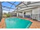 Inviting refreshing blue pool with a spa and safety fence at 5437 Misty Oak Cir, Davenport, FL 33837