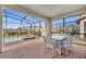 Enclosed patio area with pool, spa, and seating for six at 5437 Misty Oak Cir, Davenport, FL 33837