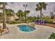 Community hot tub with stonework and palm trees at 5437 Misty Oak Cir, Davenport, FL 33837
