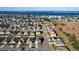 Aerial view of house and neighborhood with lake in background at 6163 Forest Ridge Way, Winter Haven, FL 33881