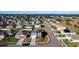 Aerial view of house and neighborhood, showcasing a lake nearby at 6163 Forest Ridge Way, Winter Haven, FL 33881