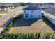 Aerial view showcasing home with solar panels and neighborhood at 6163 Forest Ridge Way, Winter Haven, FL 33881