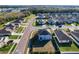 Aerial view of a modern home showcasing its well-manicured lawn and neighborhood surroundings at 6163 Forest Ridge Way, Winter Haven, FL 33881