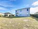 A spacious backyard featuring a well-maintained lawn, perfect for outdoor activities and relaxation at 6163 Forest Ridge Way, Winter Haven, FL 33881
