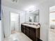 Double vanity bathroom with large mirror and walk-in shower at 6163 Forest Ridge Way, Winter Haven, FL 33881