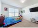 bedroom with twin bed and gaming setup at 6163 Forest Ridge Way, Winter Haven, FL 33881