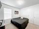 Spacious bedroom with a large bed and window blinds at 6163 Forest Ridge Way, Winter Haven, FL 33881