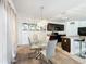 Bright dining area with glass table and modern chandelier at 6163 Forest Ridge Way, Winter Haven, FL 33881